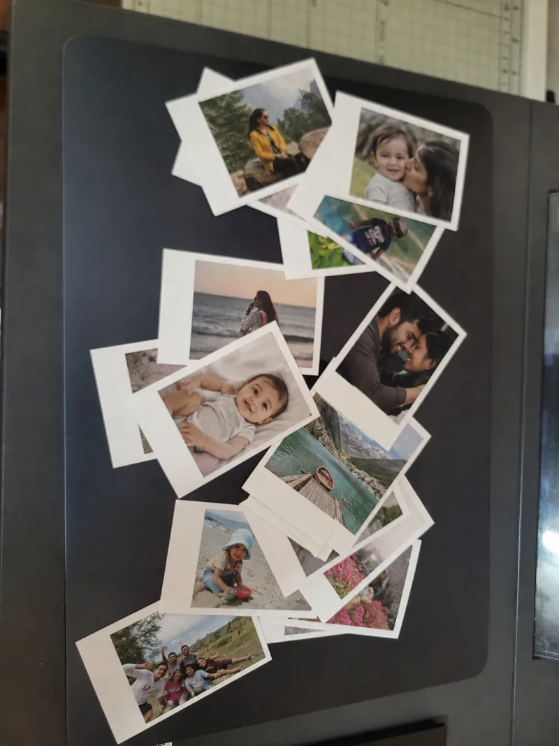 Collection of polaroid prints on a laptop showing family and beach memories